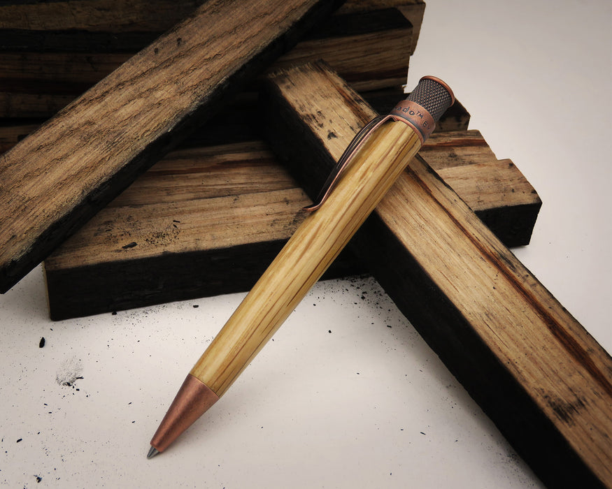 Tornado™ Woodworks - Bourbon Barrel Rollerball resting on blocks of wood